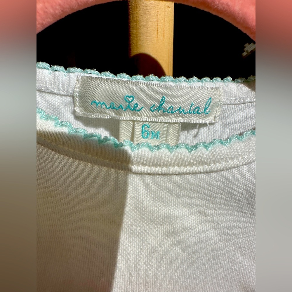 Marie Chantal white onesie with teal trim and embroidery detail. Size 6 months